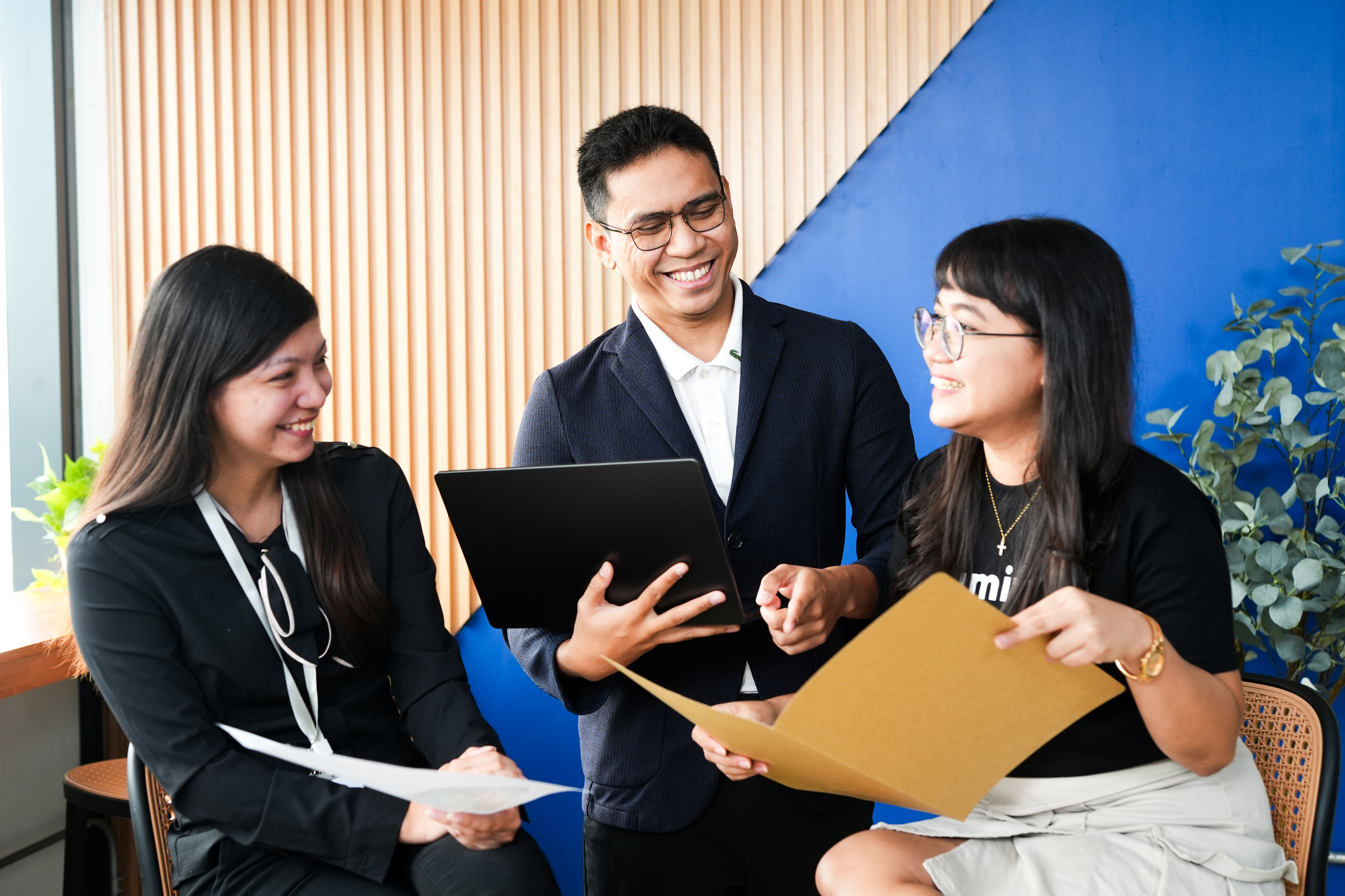Team members discussing documents during a collaborative office meeting