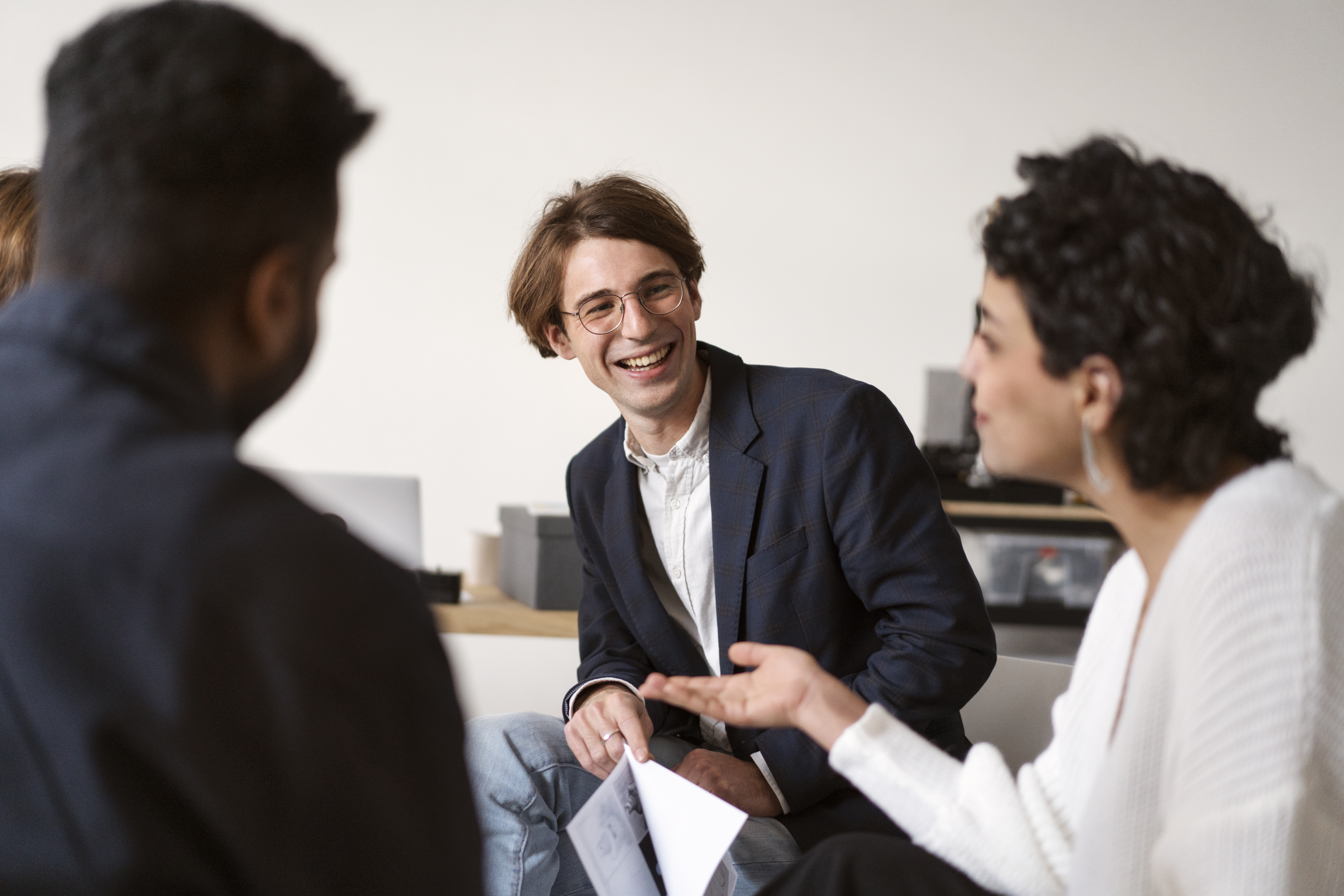 Business professionals discussing outsourcing tech talent strategy during a collaborative office meeting in 2026.